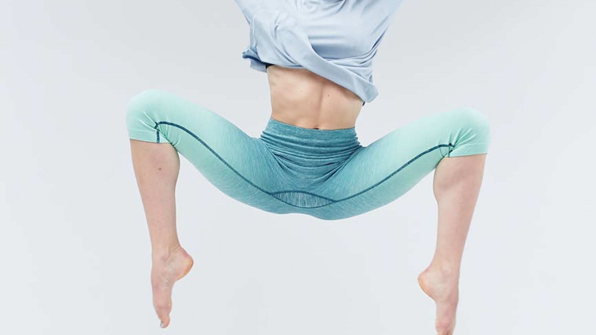 Person doing dynamic cardio movements in dark studio